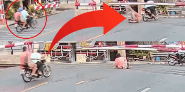 Motorcyclist Bypasses Railway Gate, Causing Wife to Get Struck by Barrier and Fall Off Bike