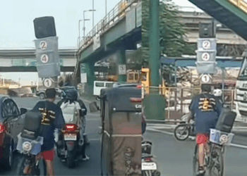 Delivery Rider in Manila Seen Balancing Boxes and a Speaker on His Head While Cycling Through Traffic