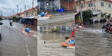 Children Ride Plastic Raft as Motorbike Tows Them Through Flooded Neighbourhood