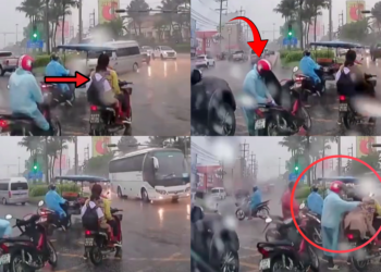 A Kind Stranger Shares a Raincoat With a Schoolchild During Heavy Rain at a Traffic Light