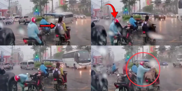 A Kind Stranger Shares a Raincoat With a Schoolchild During Heavy Rain at a Traffic Light