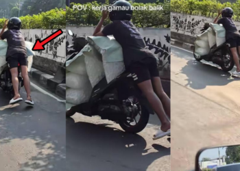 Motorcycle Rider Balances On Massive Load Through Busy City Traffic
