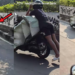Motorcycle Rider Balances On Massive Load Through Busy City Traffic