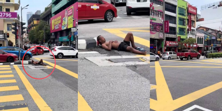 Man Casually Sleeps Under Traffic Light While Cars Keep Passing