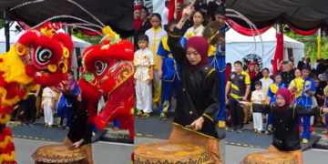 Young Female Drummer Leads Lion Dance Performance During Pesta Kaul Mukah Cultural Parade