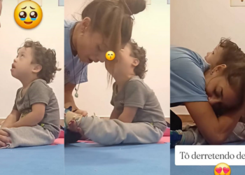 Heartfelt Moment Captured: Child with Down Syndrome Kisses Therapist while She Helps Him Put Socks on
