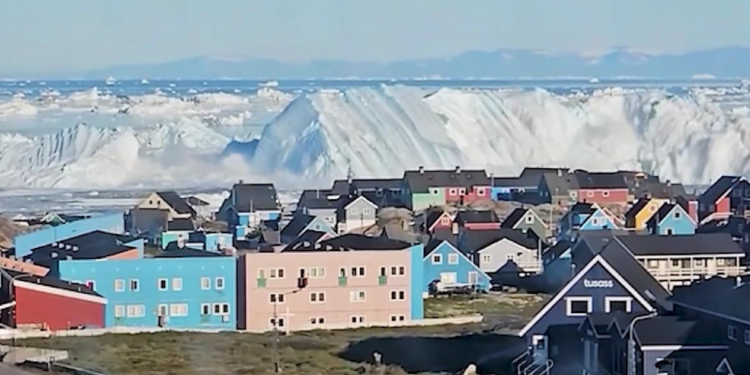 Stunning footage shows HUGE iceberg capsizing off Greenland coast