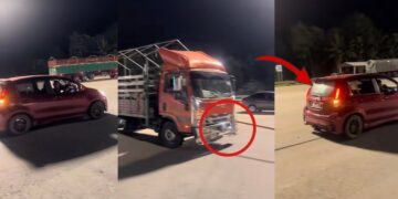 Tiny Myvi Pulls A Heavy Lorry Along The Road In Pahang