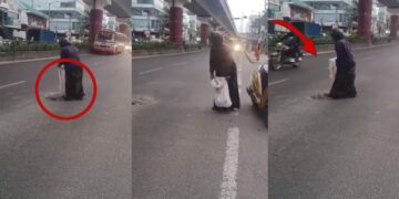 Woman Risks Busy Traffic To Fix Road Pothole Herself After Waiting For Authorities